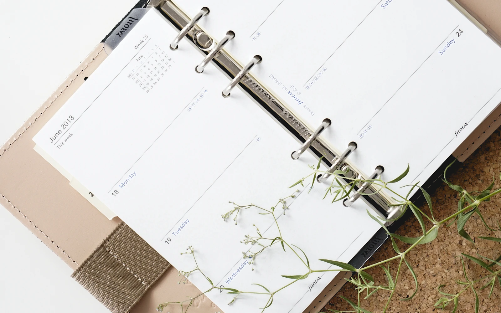 Open planner and stationery on a desk